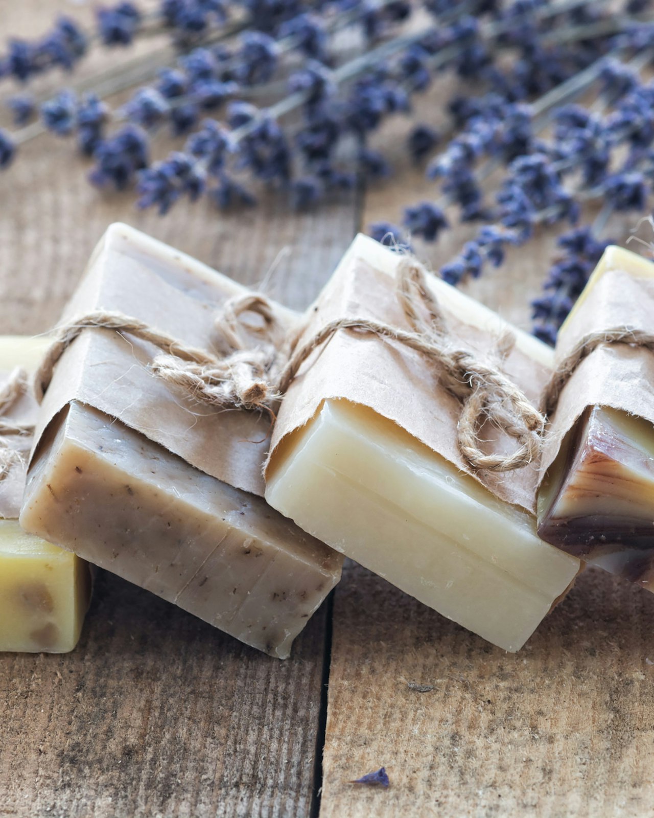 MAGIC clean-beauty bath and body products arranged on a warm wooden surface